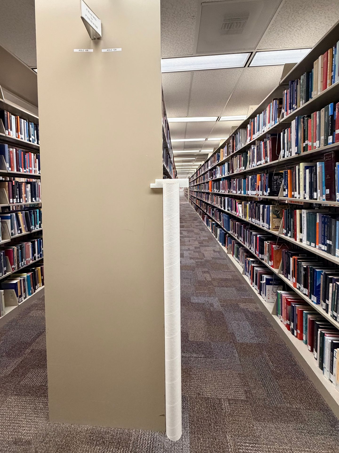 The mounting guide tool set near a library shelf