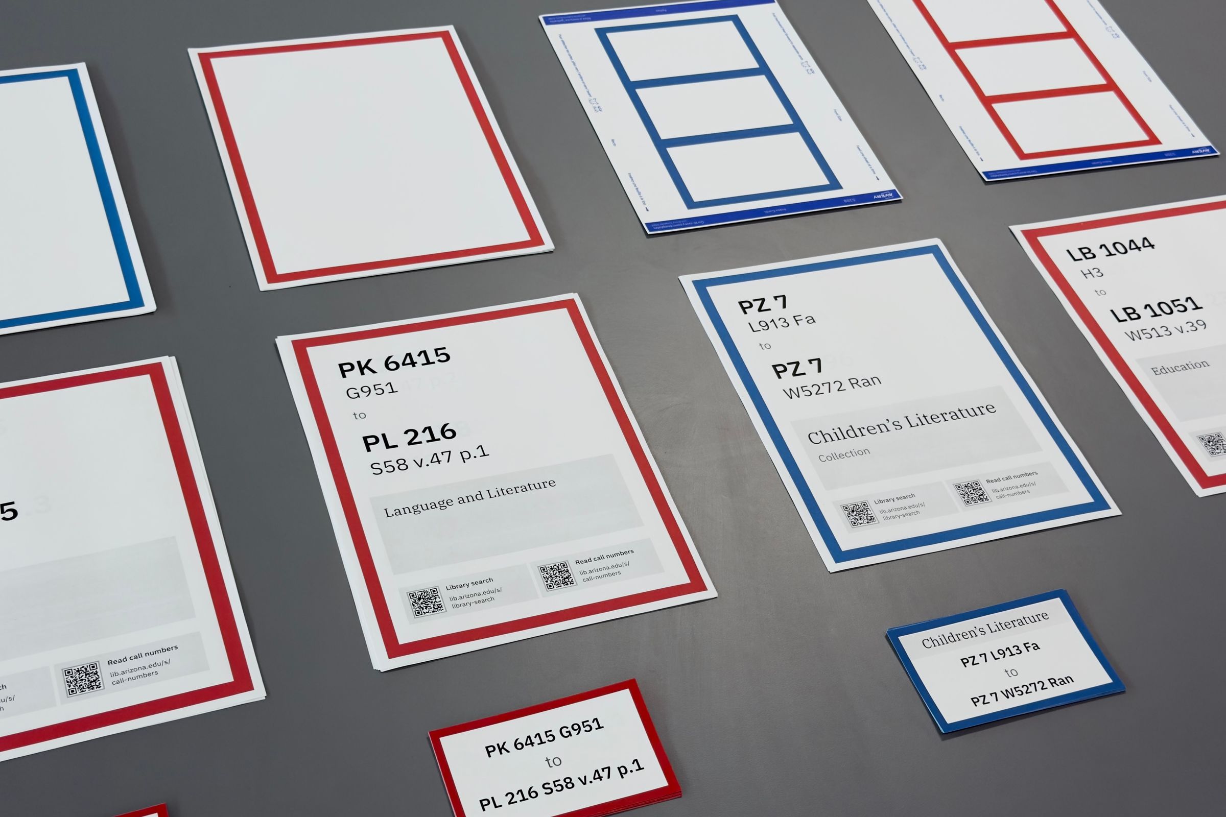 Printed library collection signs placed on a large surface